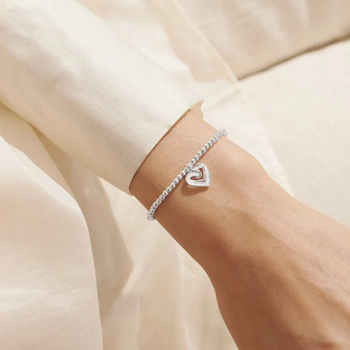 A Littles & Co. A Little Forever Thankful bracelet worn on wrist with silver beaded design and heart charm, friendship gift jewellery