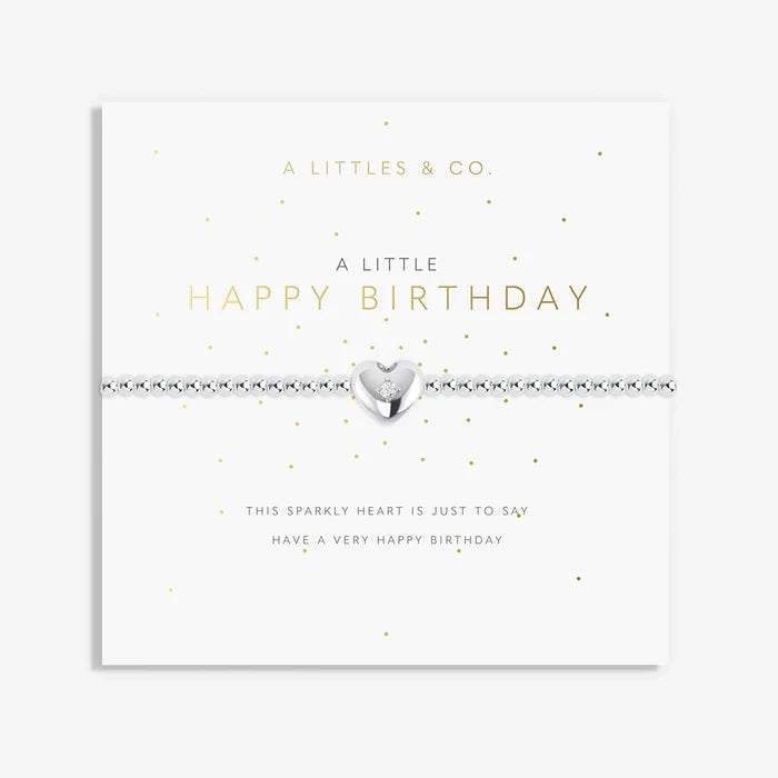 A Littles & Co A Little Happy Birthday bracelet with silver beaded stretch band and heart charm displayed on birthday sentiment card