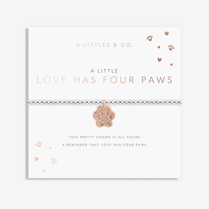 Card with a paw print charm and text about love having four paws, branded 'A Littles & Co'.
