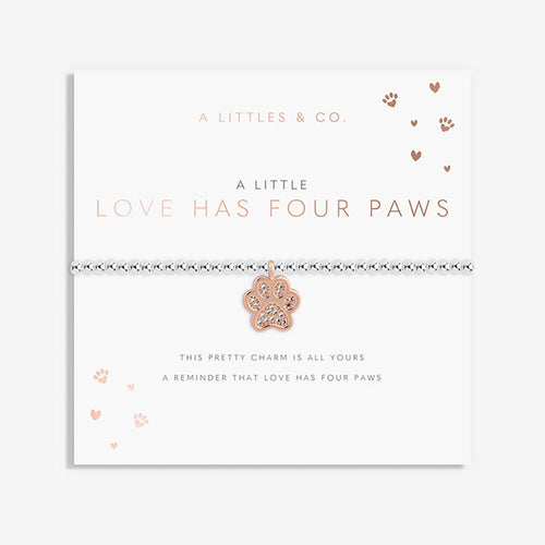 Card with a paw print charm and text about love having four paws, branded 'A Littles & Co'.