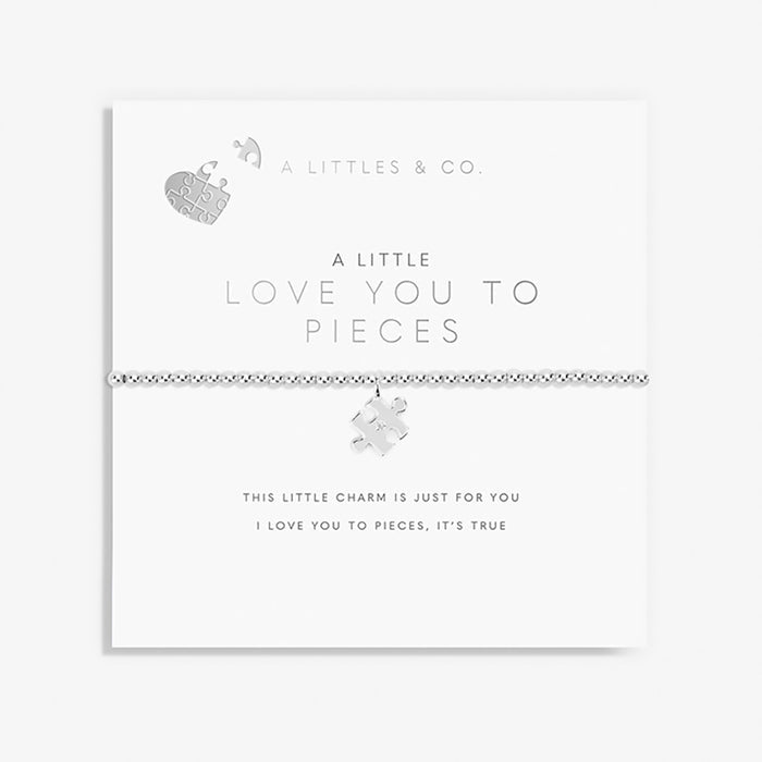 Jewelry set with puzzle piece charm on a white background, featuring 'A Littles & Co.' branding.
