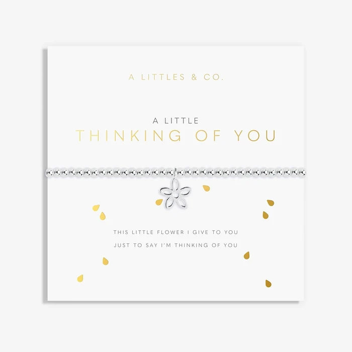 A Littles & Co A Little Thinking Of You bracelet displayed on sentiment card with silver flower charm and beaded design
