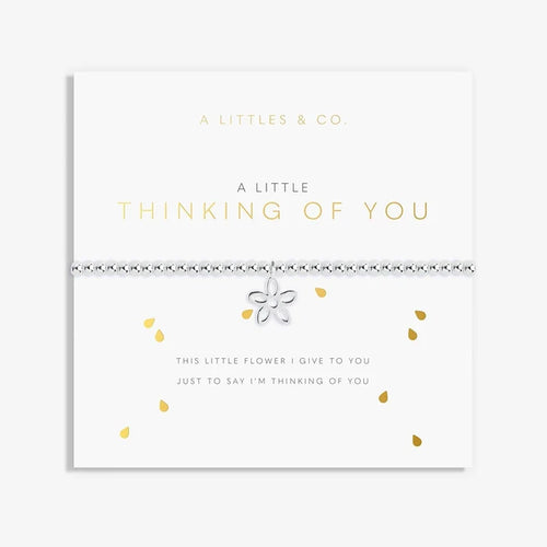 A Littles & Co A Little Thinking Of You bracelet displayed on sentiment card with silver flower charm and beaded design