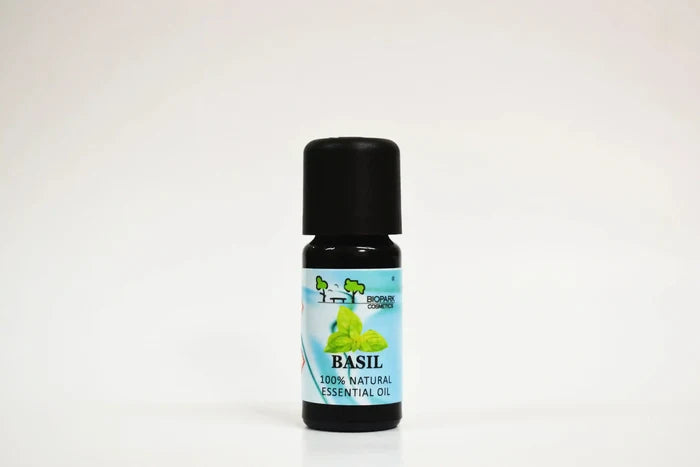 Bottle of basil essential oil on a white background