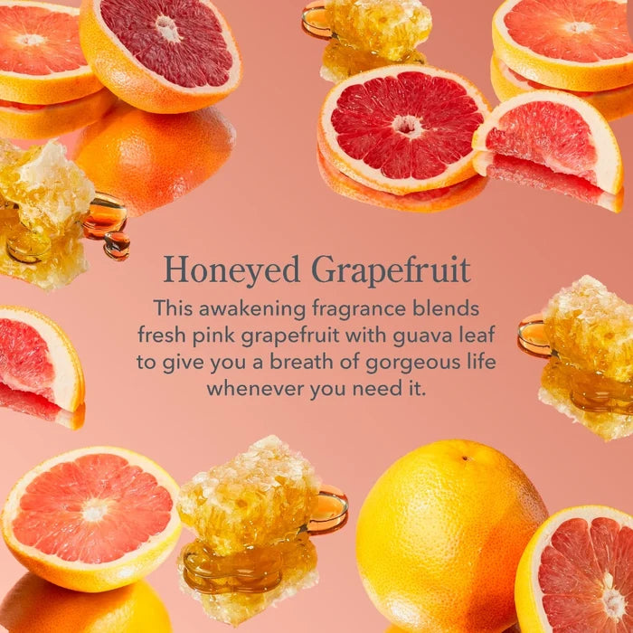 A close-up of a grapefruit with honey drizzled on top, highlighting its sweet and citrusy fragrance.