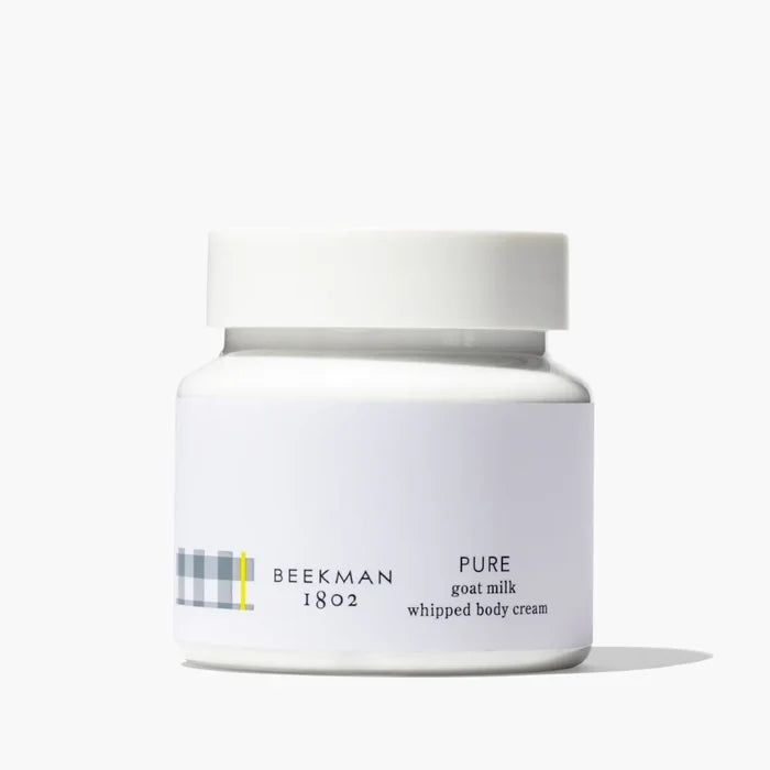 Pure face cream in a jar with a white lid, showcasing a smooth and creamy texture.