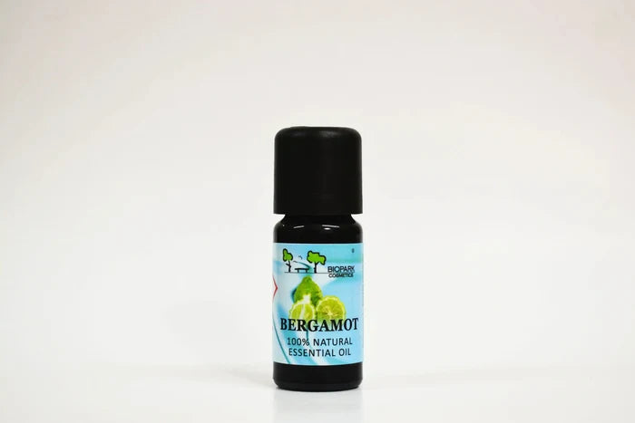 Bottle of bergamot essential oil on a white background