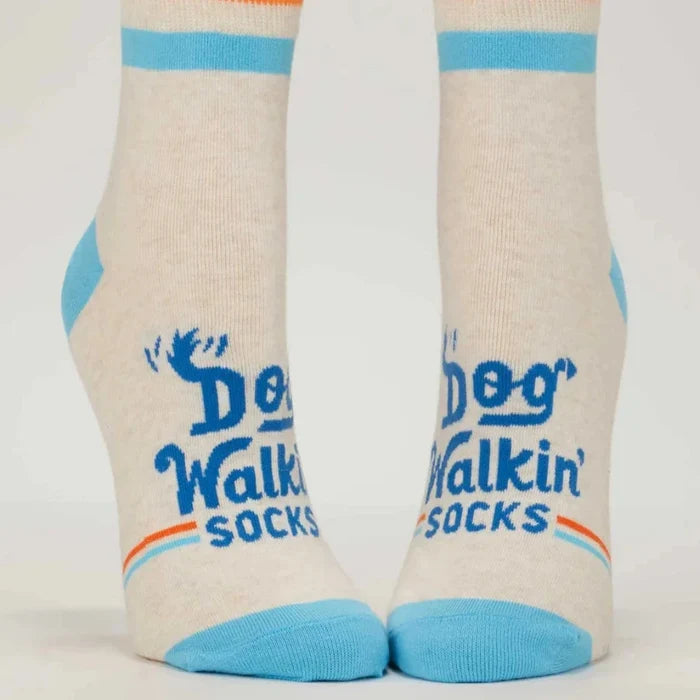 Pair of socks with 'Dog Walkin Socks' text and design on a light background