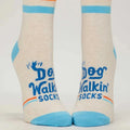 Pair of socks with 'Dog Walkin Socks' text and design on a light background