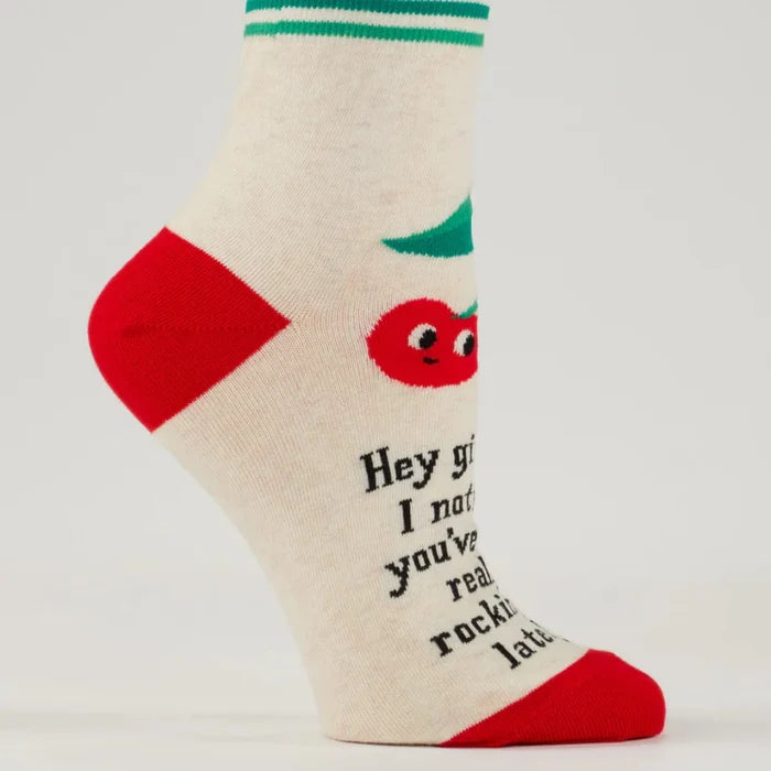 Sock with cartoon tomato and text on a plain background