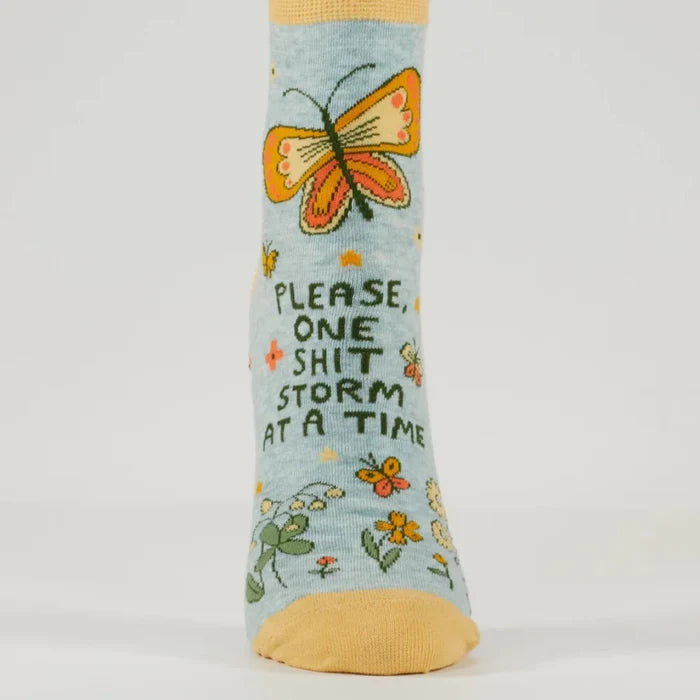 Sock with butterfly design and text on a light blue background