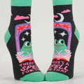 Pair of socks with a witch design and text on a white background
