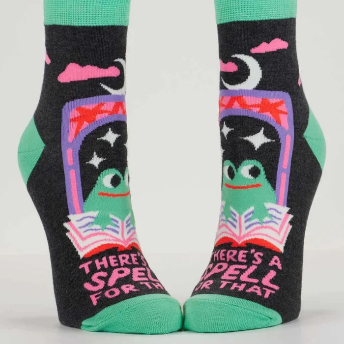 Pair of socks with a witch design and text on a white background