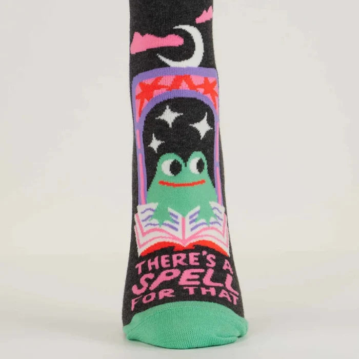 Socks with a frog design and text 'There's a spell for that' on a white background