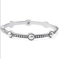 The Brighton Pretty Tough Stud Bangle combines edge and elegance in one striking piece.