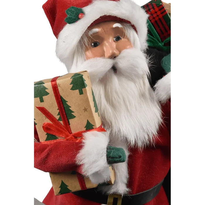 Close up of Byers' Decorative figure of Santa Claus holding gifts and a sack on a white background