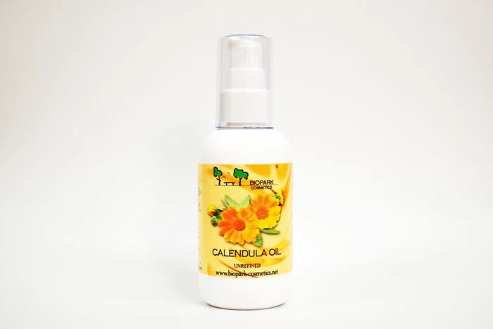 Bottle of calendula oil with a yellow label on a white background