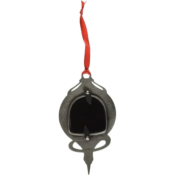 Decorative black metal ornament with a red ribbon on a white background
