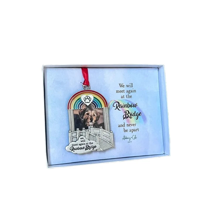 Memorial ornament with rainbow design and text on a blue background
