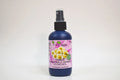 Bottle of organic chamomile German hydrosol with a spray nozzle on a white background
