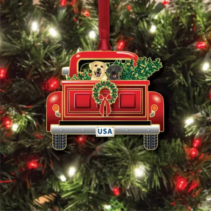 Christmas ornament of a red truck with dogs and wreath on a tree