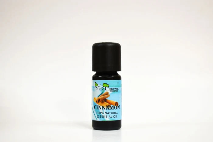 Bottle of cinnamon essential oil on a white background