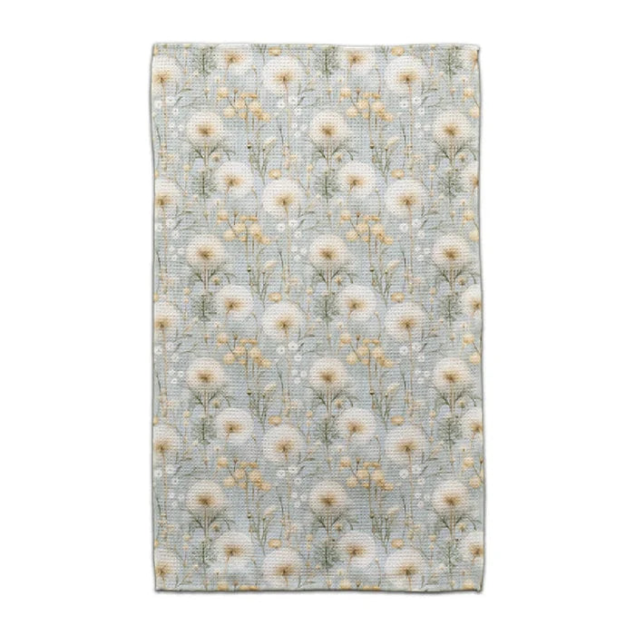 A blue and white floral print blanket draped elegantly, showcasing intricate flower patterns on a soft fabric.