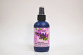 Bottle of organic clary sage hydrosol with a floral label on a white background