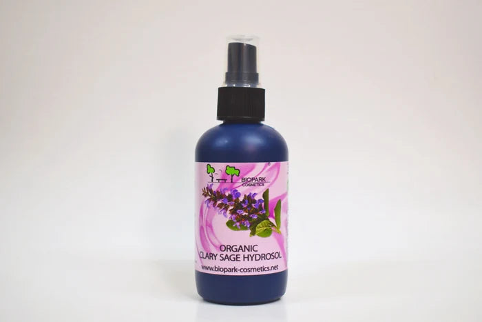Bottle of organic clary sage hydrosol with a floral label on a white background