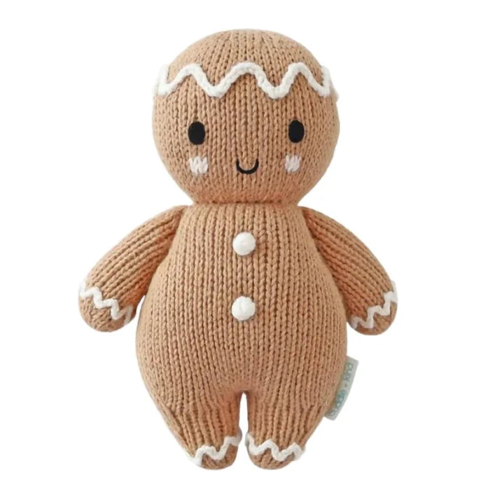 Cuddle + Kind Baby Gingerbread Doll – White Icing Edition, handmade knit holiday plush with embroidered details.
