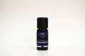 Bottle of Elite Oils Cedarwood essential oil on a white background