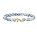 Grey marbled beaded bracelet with a  snow leopard charm on a white background