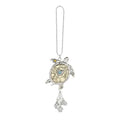 Silver turtle-shaped keychain with heart design on a white background
