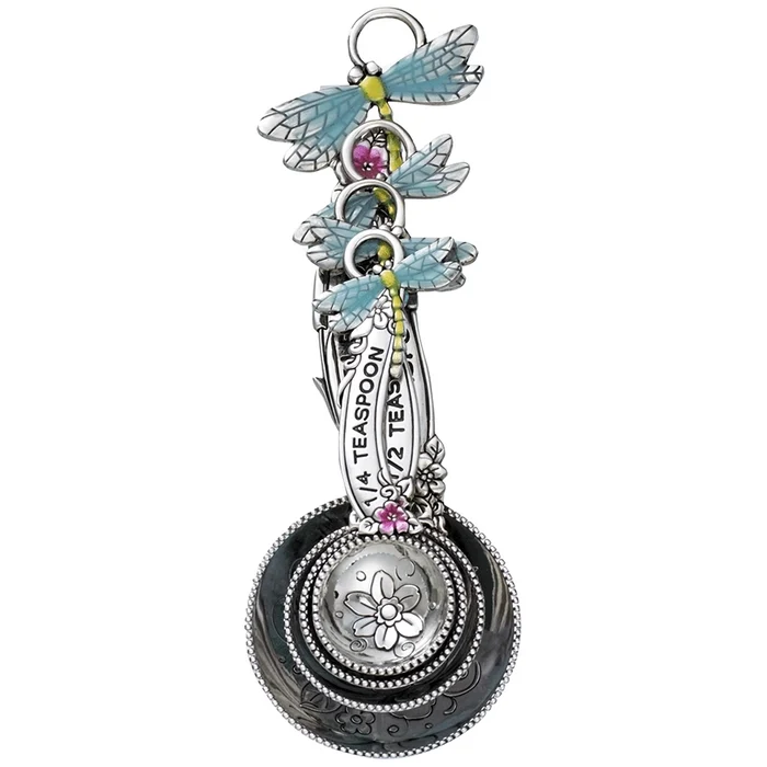 Decorative spoon with dragonfly designs and floral elements on a white background