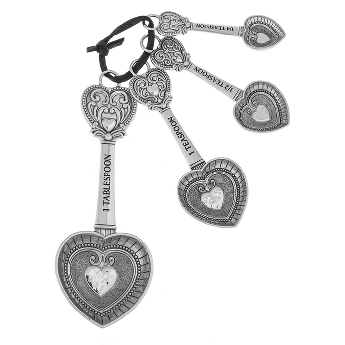 Silver key-shaped keychain with heart designs on a white background