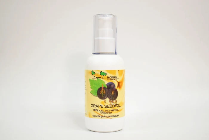 Bottle of grape seed oil with a label on a white background