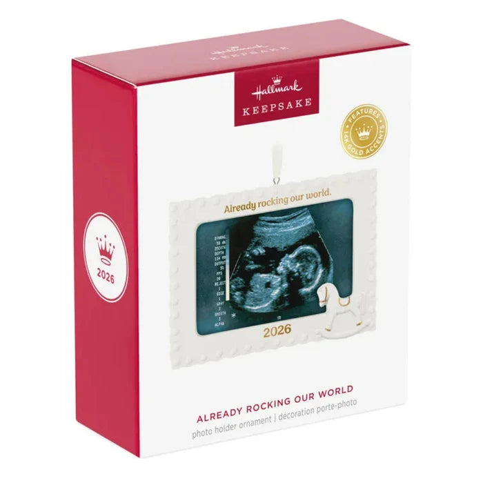 Hallmark Keepsake ornament packaging with ultrasound image and 'Already rocking our world' text.