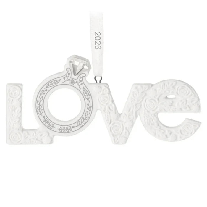 Silver 'LOVE' ornament with intricate designs on a white background