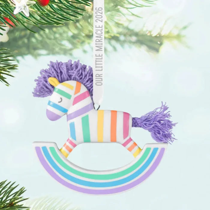 Colorful rocking horse ornament with tassels on a light blue background