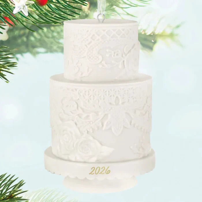 White textured cake ornament with '2026' on a light blue background