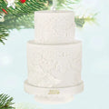 White textured cake ornament with '2026' on a light blue background