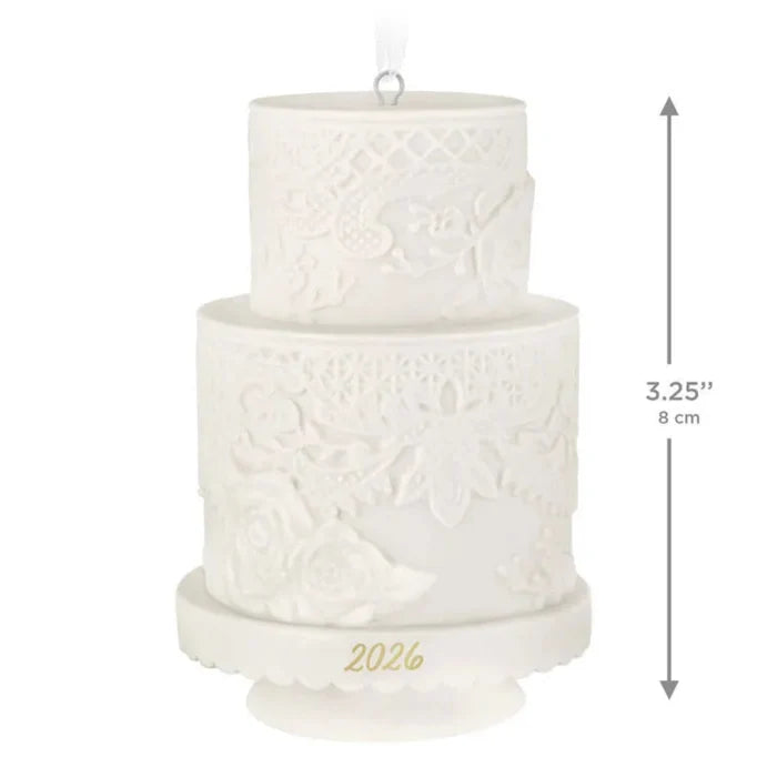 Two-tiered white decorative cake ornament with '2026' on a white background