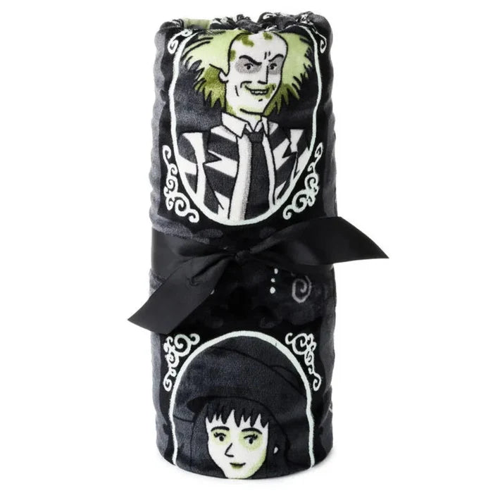Rolled blanket with characters from the Beetlejuice movie  on a white background
