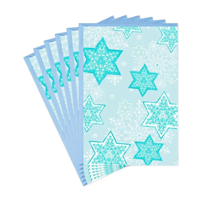 Pack of blue paper sheets with star patterns on a white background