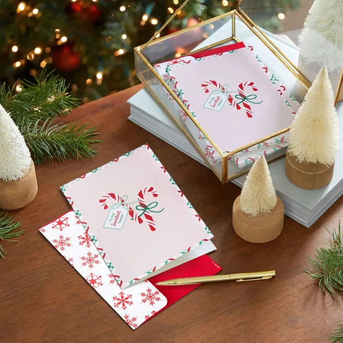 Peppermint themed Christmas cards on a wooden surface