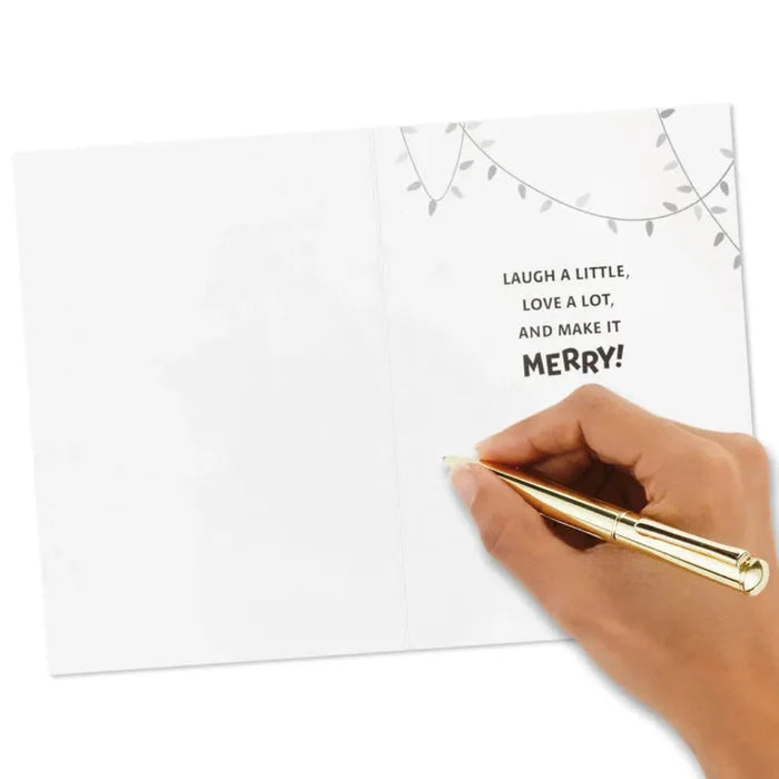 Hand holding a gold pen over a card with text on a white background
