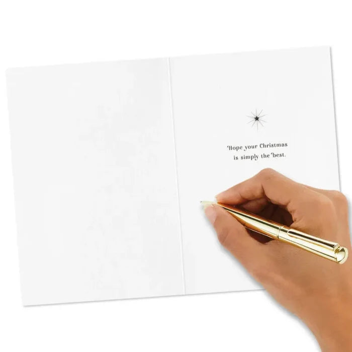 Hand holding a gold pen over a white card with text on a white background