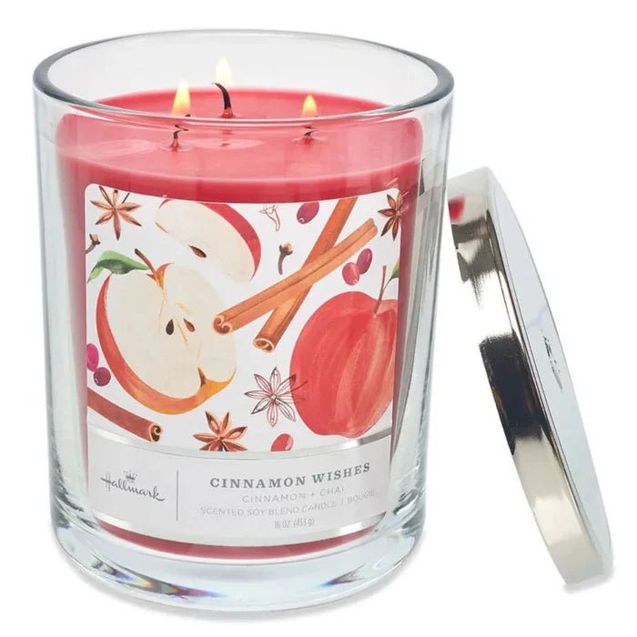 Hallmark 3 wick Candle with a 'Cinnamon Wishes' label featuring apples and cinnamon sticks on a white background.