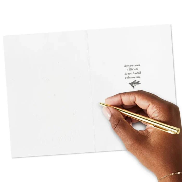 Hand holding a gold pen over a white card with text and a butterfly illustration.