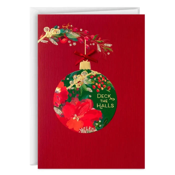 Red Christmas card with a floral ornament design and 'Deck the Halls' text on a white background.